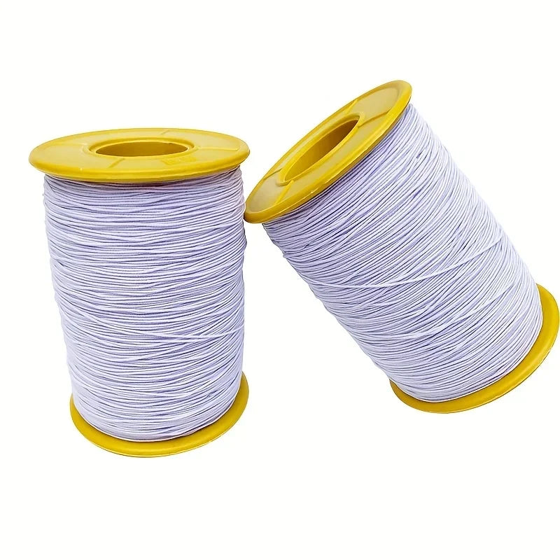 Spool of purple elastic sewing thread with a yellow plastic core