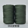 Two spools of dark green yarn or cord for crafting