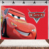 A close-up of a red cartoon race car, Lightning McQueen, against a red diamond pattern backdrop.