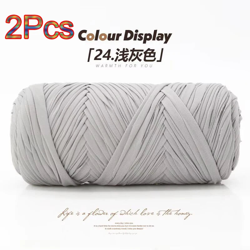 Two skeins of grey elastic yarn coiled and displayed for crafting