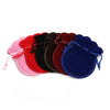 A set of ten velvet drawstring gift bags in various colors including pink, red, black, and blue.