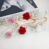 Gold rose pattern curtain ties featuring red and pink fabric flowers and pearl metal buckles