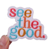 Pink and orange embroidered letter iron-on patches spelling out See the good