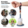 A hand holds a portable yarn holder with a fabric strap and a rolled yarn core, shown in various contexts like café, train, h