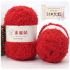 A bright red, fluffy yarn ball labeled as Soft Coral Velvet Yarn for Crafting.
