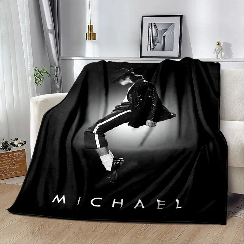 A black flannel throw blanket featuring a retro printed image of a person in dark clothing.