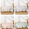 Four patterns of waterproof baby play mats with anti-slip backing displayed on a wooden surface.
