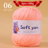 A skein of soft orange acrylic yarn labeled as 6pcs equal to 300g for hand knitting thread.