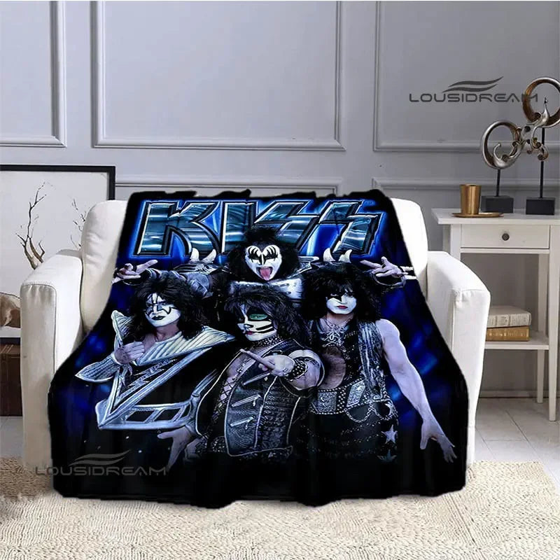 A dark printed flannel travel blanket featuring three gothic-themed figures with black and white makeup and dark clothing.