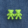 A pair of bright lime green adjustable bear button pins for jeans
