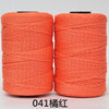 Two spools of orange hand knitting and crochet cord for crafting