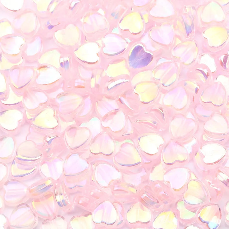 A close-up view of pink acrylic heart beads for jewelry making
