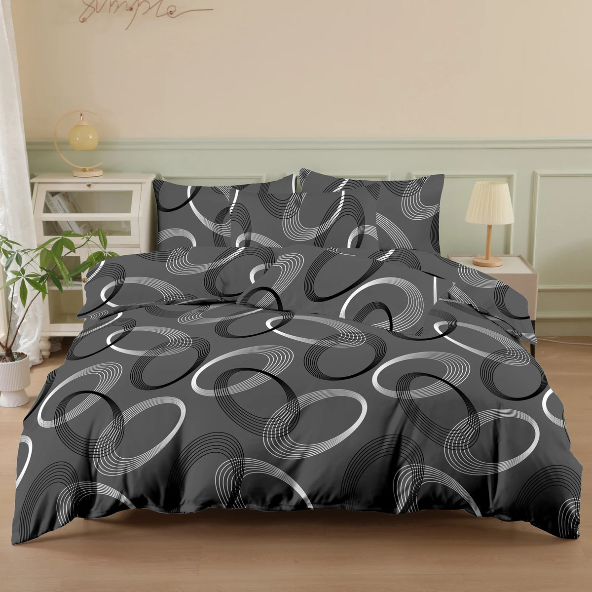 A dark gray printed quilt set featuring concentric white and gray circular patterns on a bed.