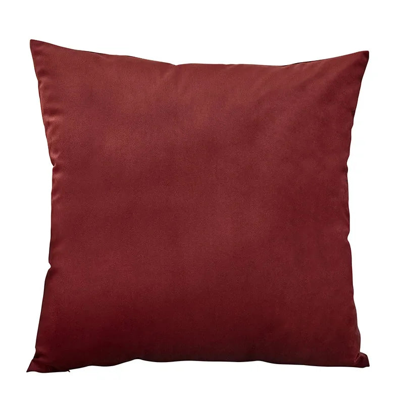 A deep burgundy velvet throw pillow cover resting on a white background.