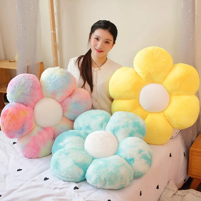 A collection of yellow and light blue sunflower plush flowers arranged on a white surface.