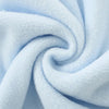 A soft light blue fleece throw blanket with a textured, fluffy appearance, tightly rolled.