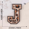 A leopard print letter J iron-on patch with a dark brown border and gold lettering.