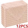 A stack of light pink decorative cloth napkins with fringed edges.