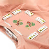 A pink fabric shows various magnetic embroidery hoops and a pair of embroidery scissors.