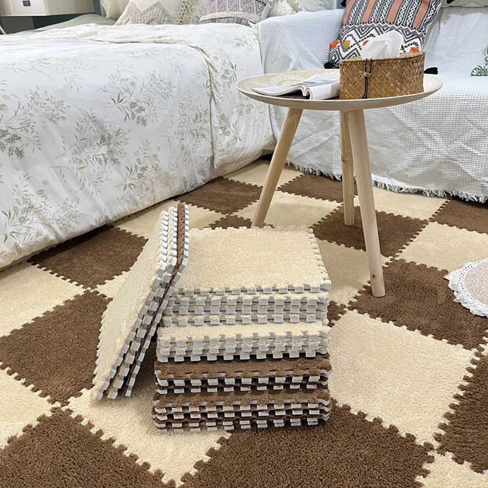 A beige play mat features stacked square tiles made of soft plush EVA foam on a brown rug.