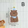 A cute cartoon bear hanging ornament with a yellow star on a white background.