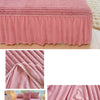 A pink plush bed skirt linen set featuring quilted fabric and a gathered design.