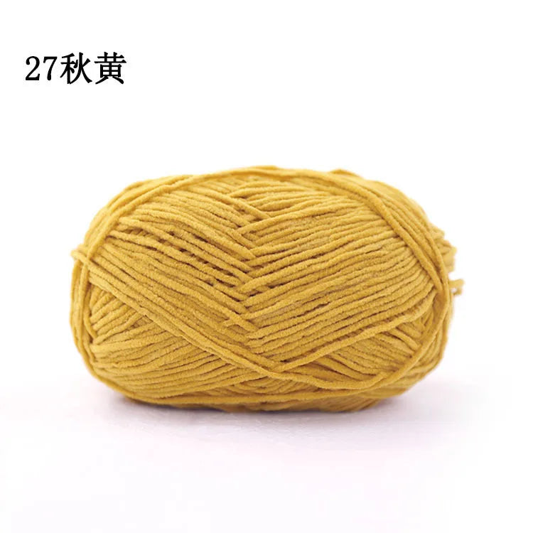 A ball of 3mm matte chenille yarn in a golden yellow color for knitting and crochet.
