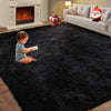 A toddler sits on a black ultra-soft plush living room rug in front of a light-colored sofa and fireplace.