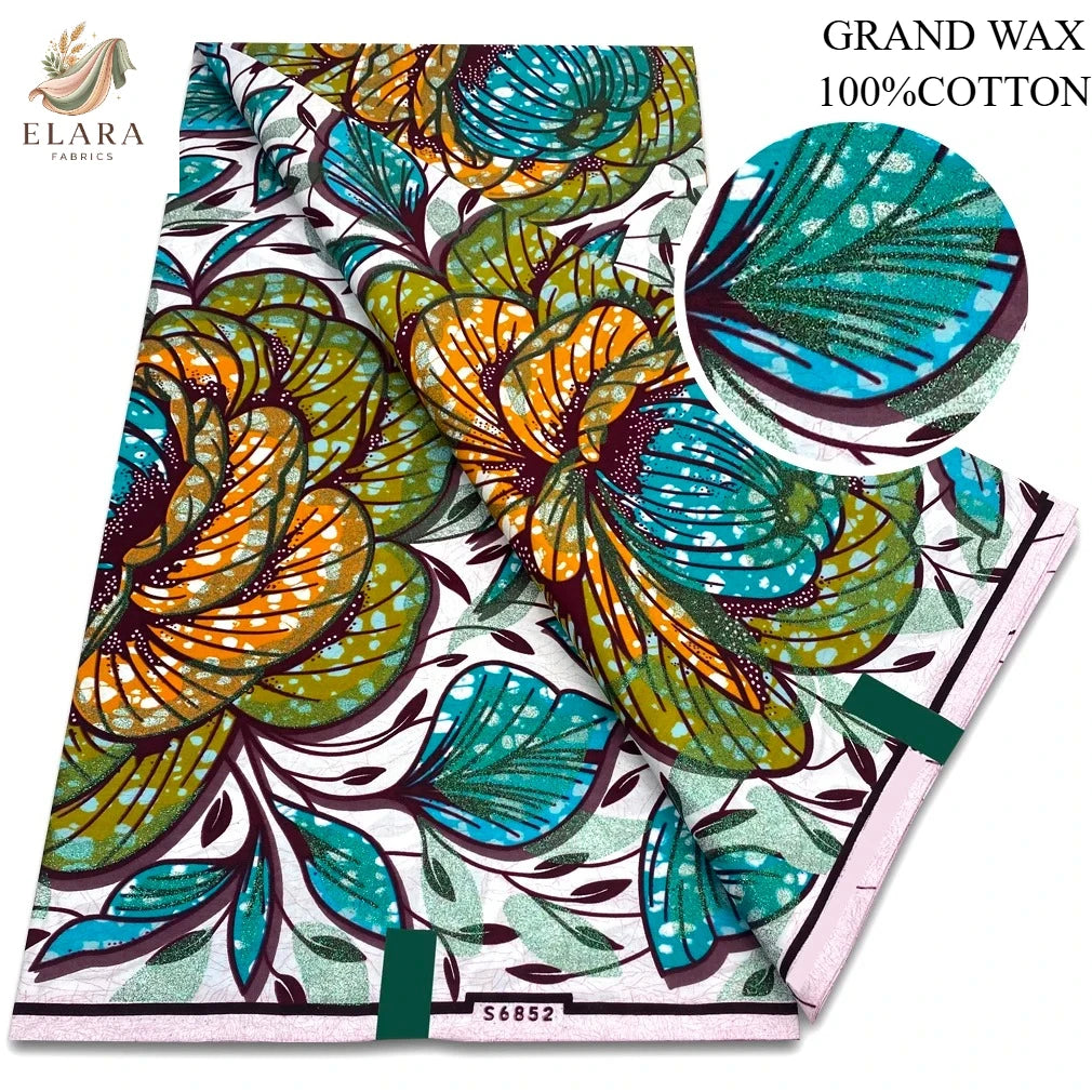 A roll of brown, orange, and teal African wax print fabric with green leaves.