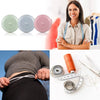 A woman holds a pink retractable double-sided measurement tape next to a gray and green version, with a measuring tape laid o