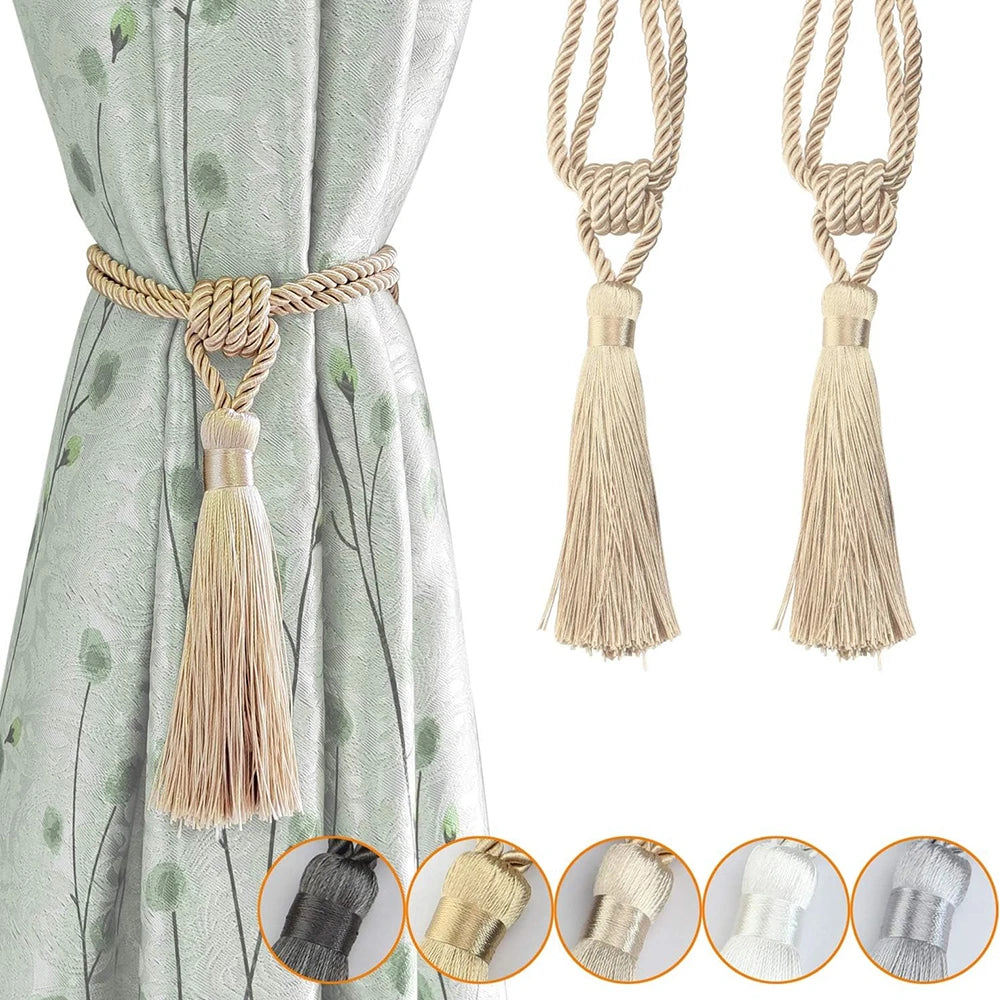 Elegant curtain tiebacks with braided rope and tassels shown against a light green fabric.