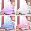 Various pink and purple princess dome mosquito nets displayed on beds in a bedroom setting.
