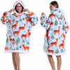 A woman models an oversized patchwork fleece hoodie in white and orange patterns.