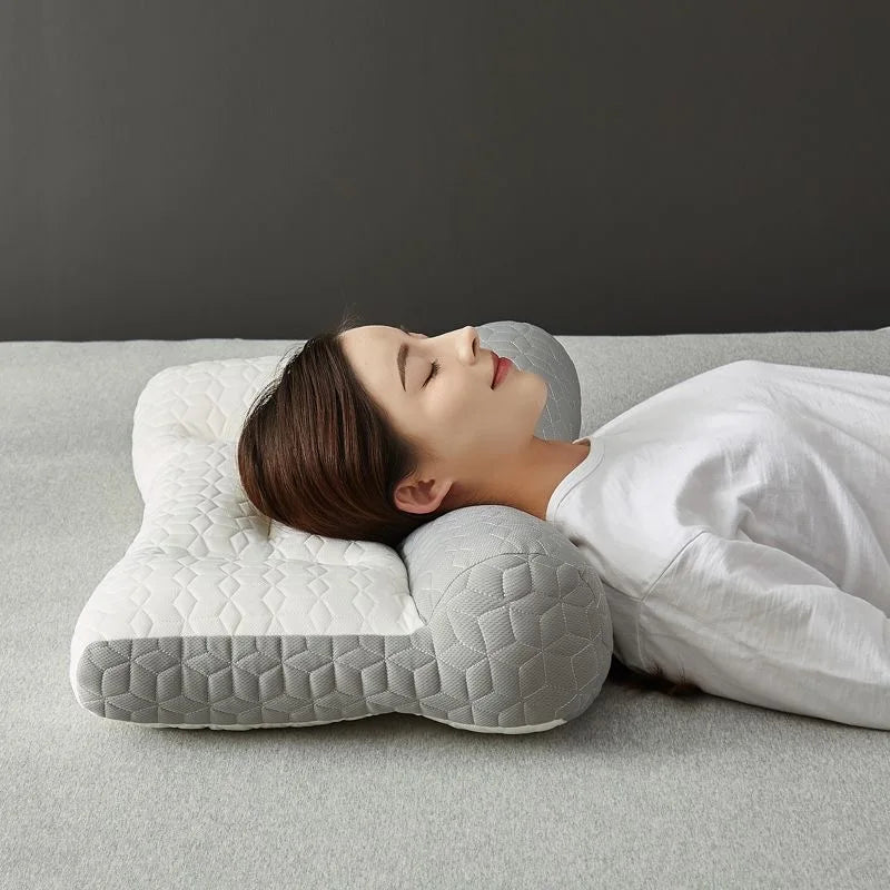 A person is lying down using a gray 3D ergonomic contour pillow for neck and spine support.