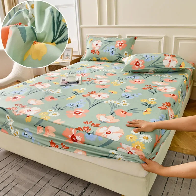 A floral fitted sheet set with green and pink flowers is displayed on a bed, showing a close-up of the fabric pattern.