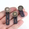 A hand holds three universal waist extender buttons for jeans and pants, featuring a gold-toned finish.