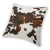 A square cushion cover featuring a brown and white cowhide print.