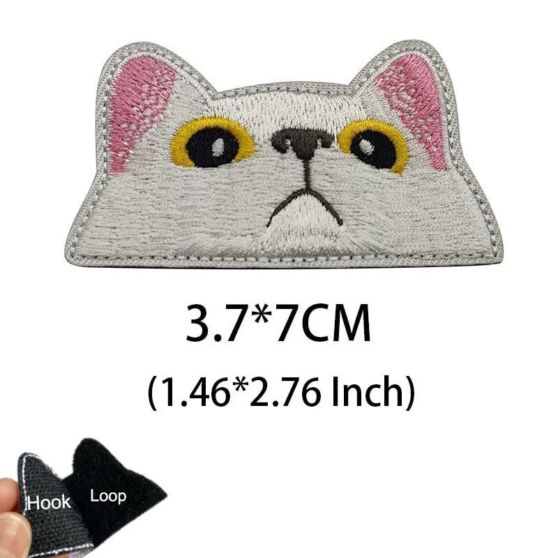 Gray cat embroidered patch with yellow eyes and pink ears featuring a funny animal meme design