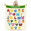 A beige flannel throw blanket featuring various colorful alphabet letters from Sesame Street fonts.