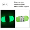 A spool of bright lime green glow-in-the-dark polyester yarn labeled G005F for knitting and crochet.