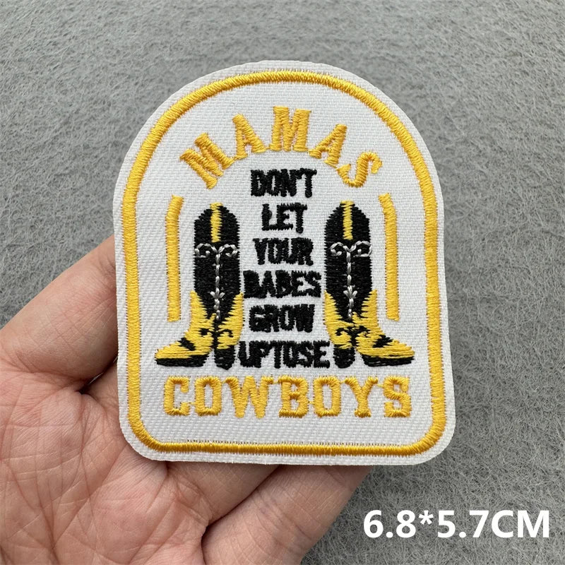 Yellow and black embroidered patch featuring the text MAMAS DON'T LET YOUR BABES GROW UP TOSE COWBOYS