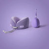 A purple U-shaped memory foam travel neck pillow with a strap is shown against a light purple background.