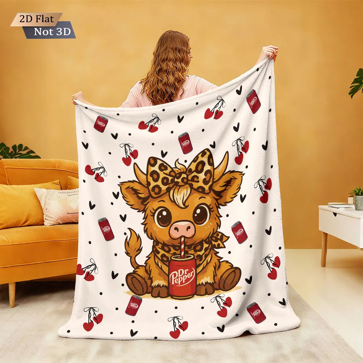 A white flannel blanket featuring a cartoon Highland cow print with red pepper cans and leaves.