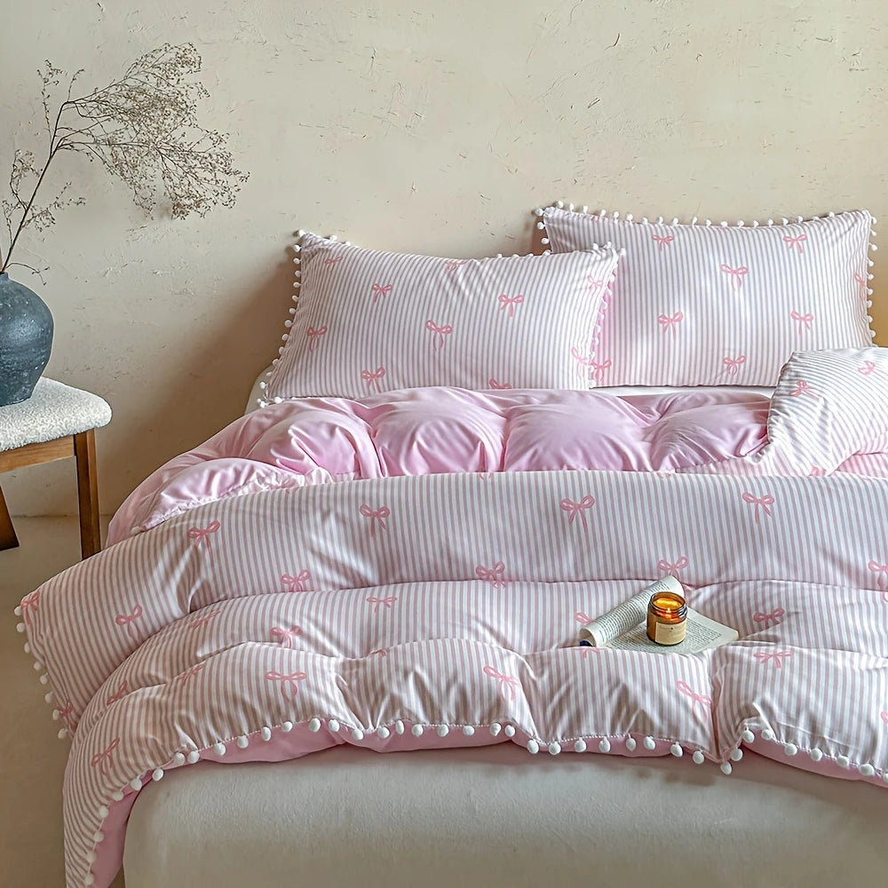 A pink quilt duvet set featuring a striped fabric with small pink bows and decorative piping.