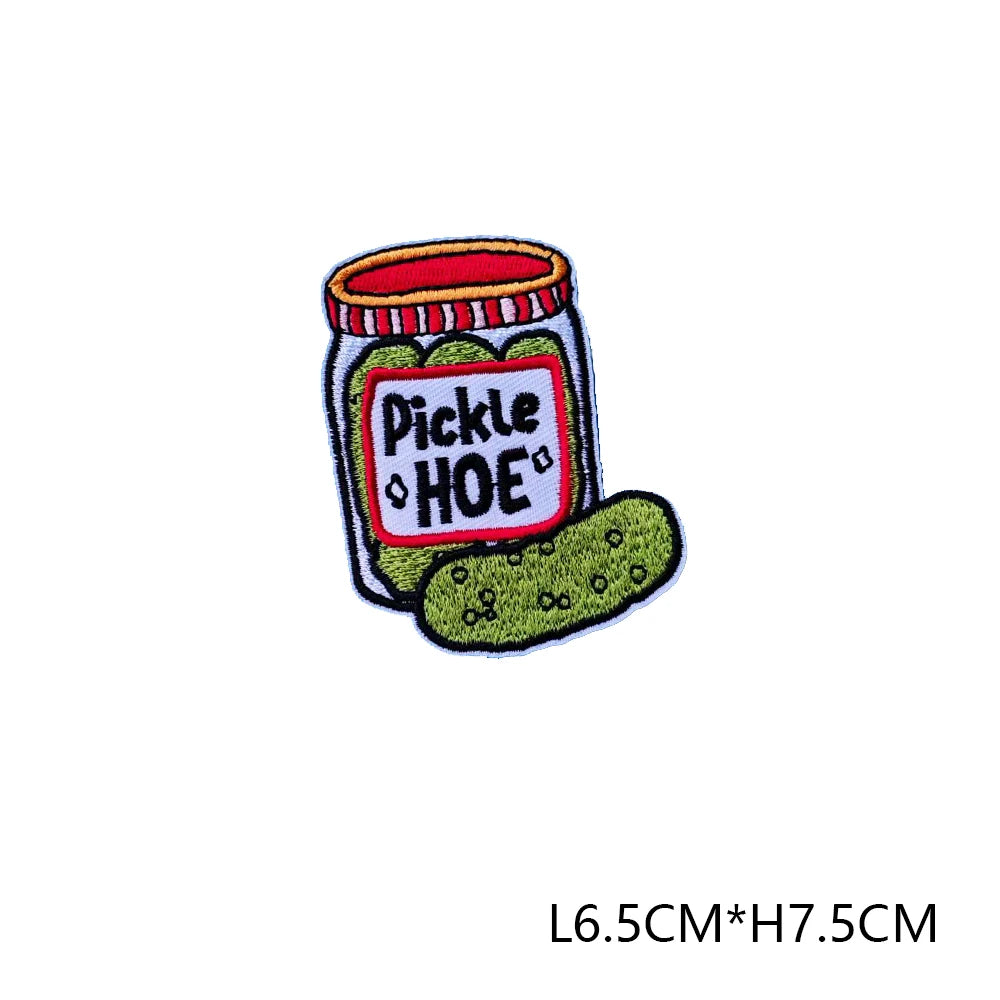 An embroidered letter patch depicting a jar of pickles labeled PICKLE HOE