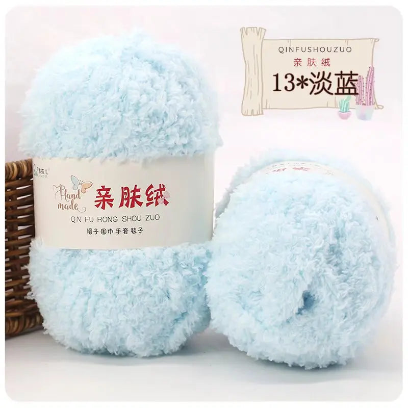A fluffy light blue velvet yarn ball used for crafting and knitting.