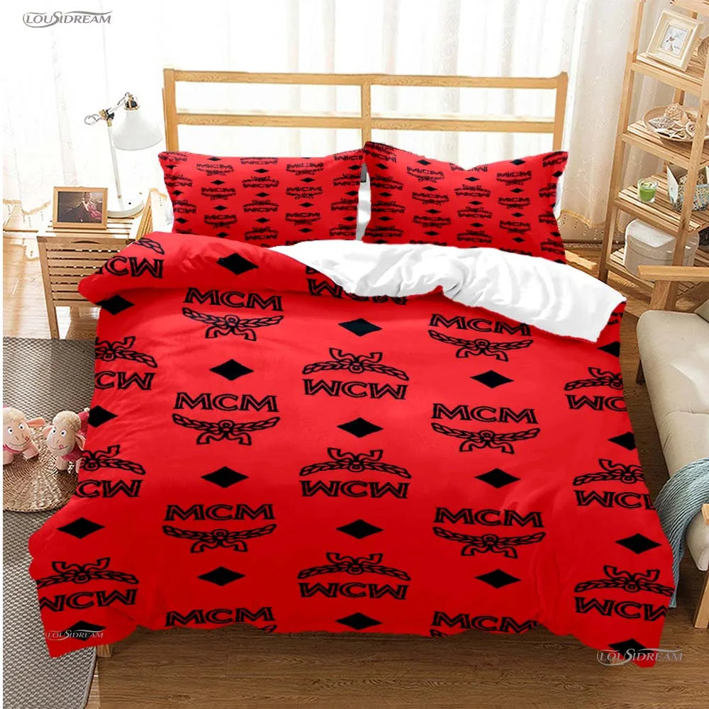 A red duvet cover set with black MCM pattern featuring embroidered symbols and pillows on a bed.