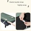 A close-up of an elastic buckle strap being tightly wrapped around a dark green fabric dining bench cover.