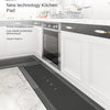 A black kitchen mat is placed on a white marble countertop in a modern kitchen setting.