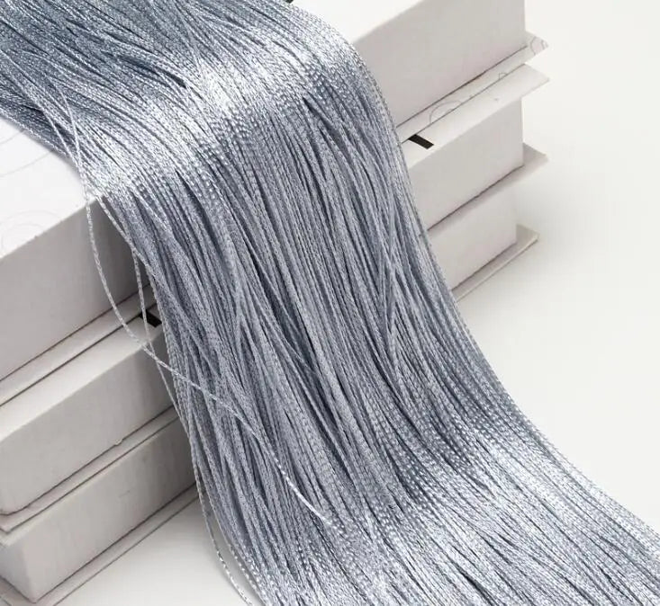 Silver thread curtain tie-back for doors and windows displayed in a box.